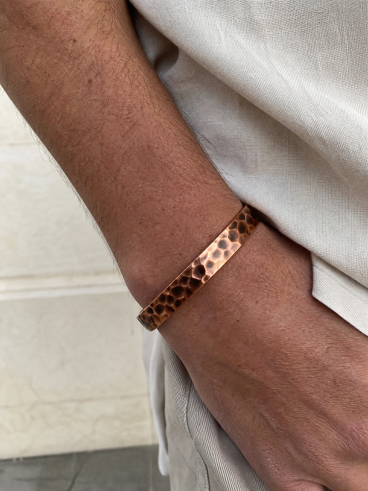 The Hammered Copper Cuff worn on wrist